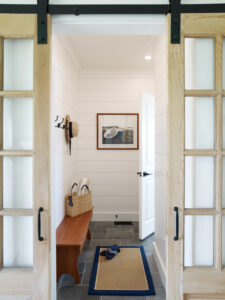 Beautiful white mudroom, an entryway to a beautifully designed and decorated home